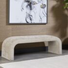 Curved taupe upholstered bench with seamless modern silhouette and low-profile design.