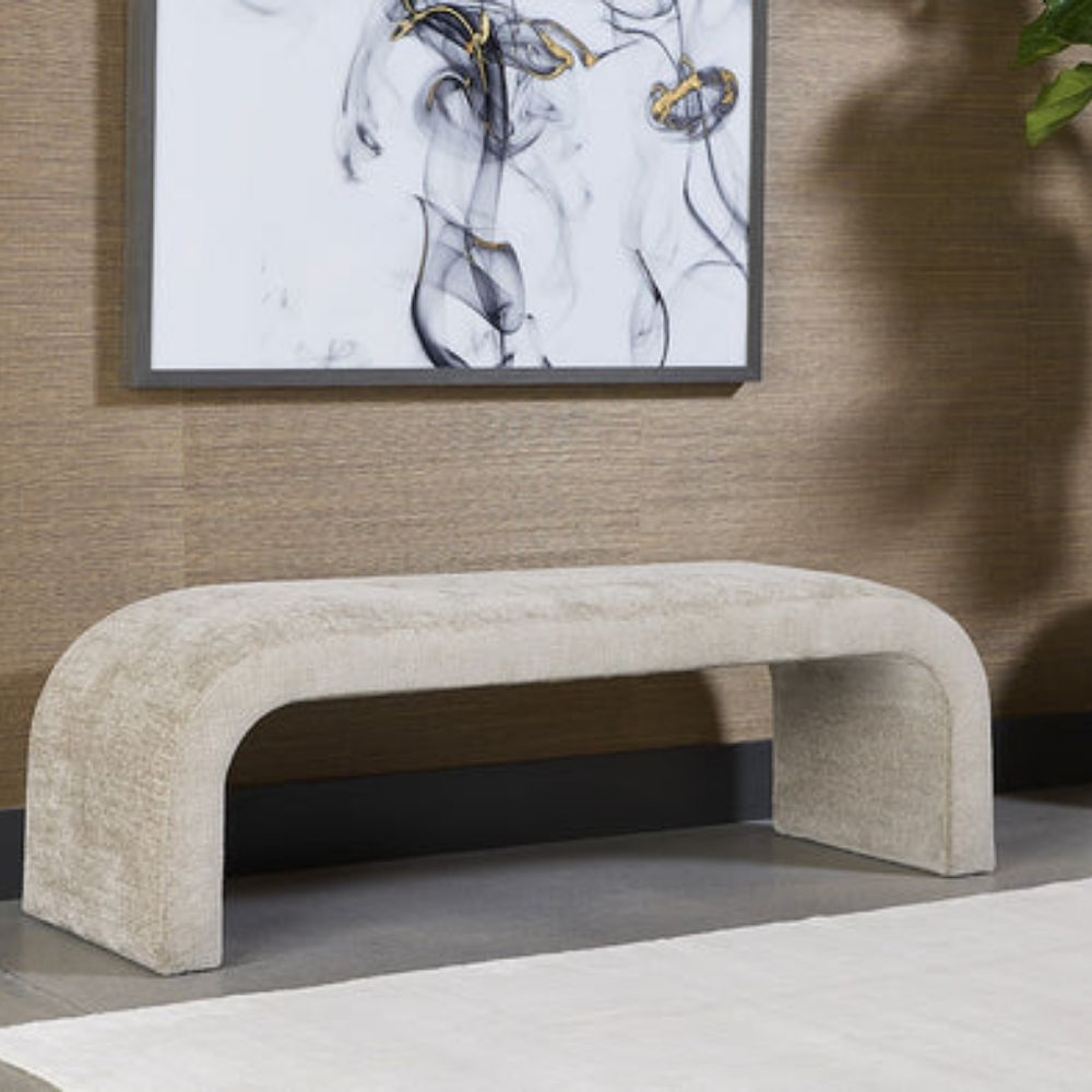 Curved taupe upholstered bench with seamless modern silhouette and low-profile design.