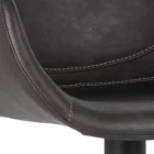 Modern swivel counter stool with black faux leather seat, curved arms, and black metal spider-leg base.