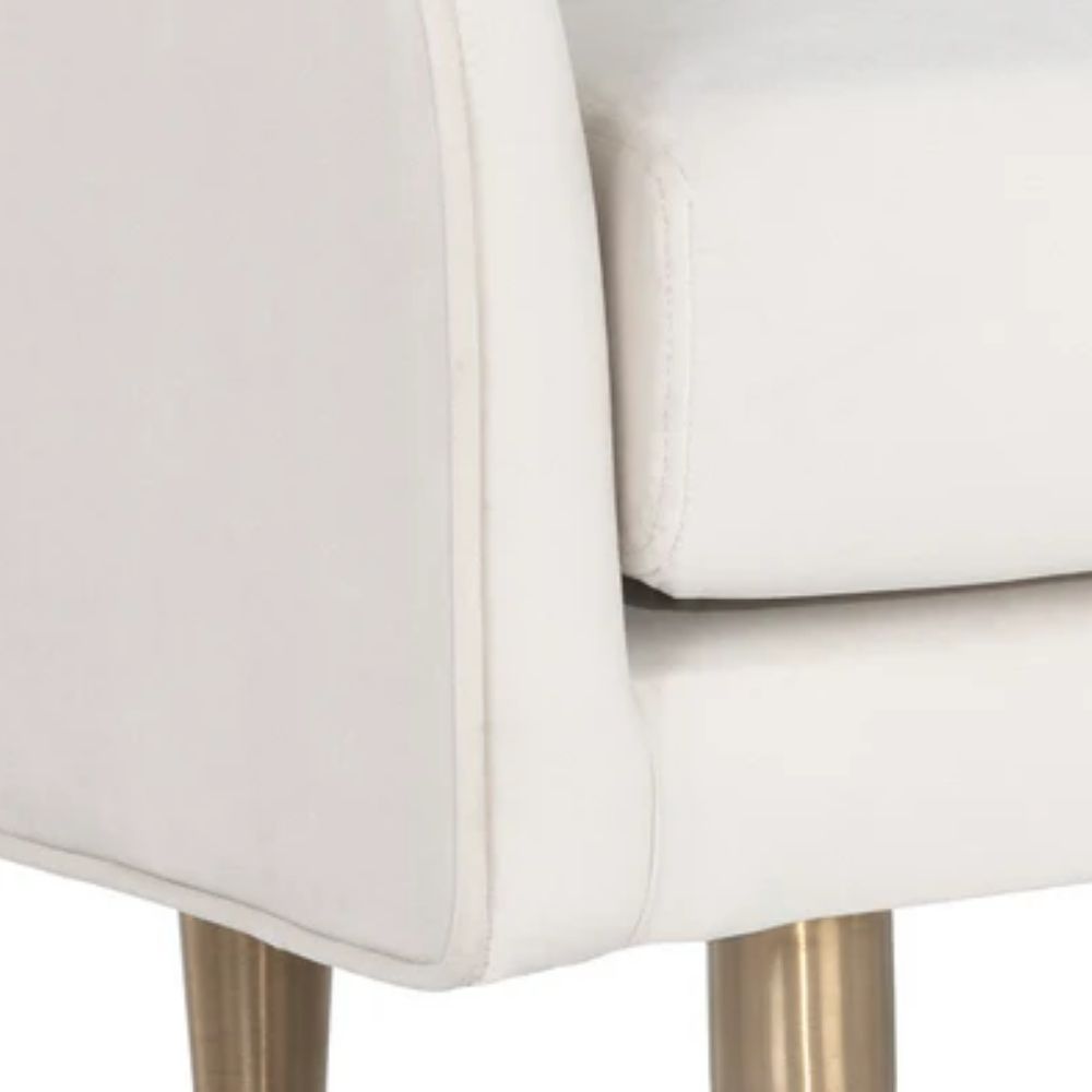 White upholstered bench with slim curved backrest and tapered gold-finished legs.