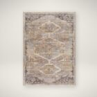 Traditional-inspired rug in muted shades of taupe, grey, and gold with a distressed medallion pattern.