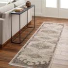 Traditional-inspired rug in muted shades of taupe, grey, and gold with a distressed medallion pattern.