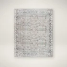 Vintage-inspired rug with a soft distressed pattern in blush, cream, and hints of blue with a classic border.