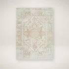 Beige and ivory machine woven rug with a soft medallion and distressed traditional pattern.