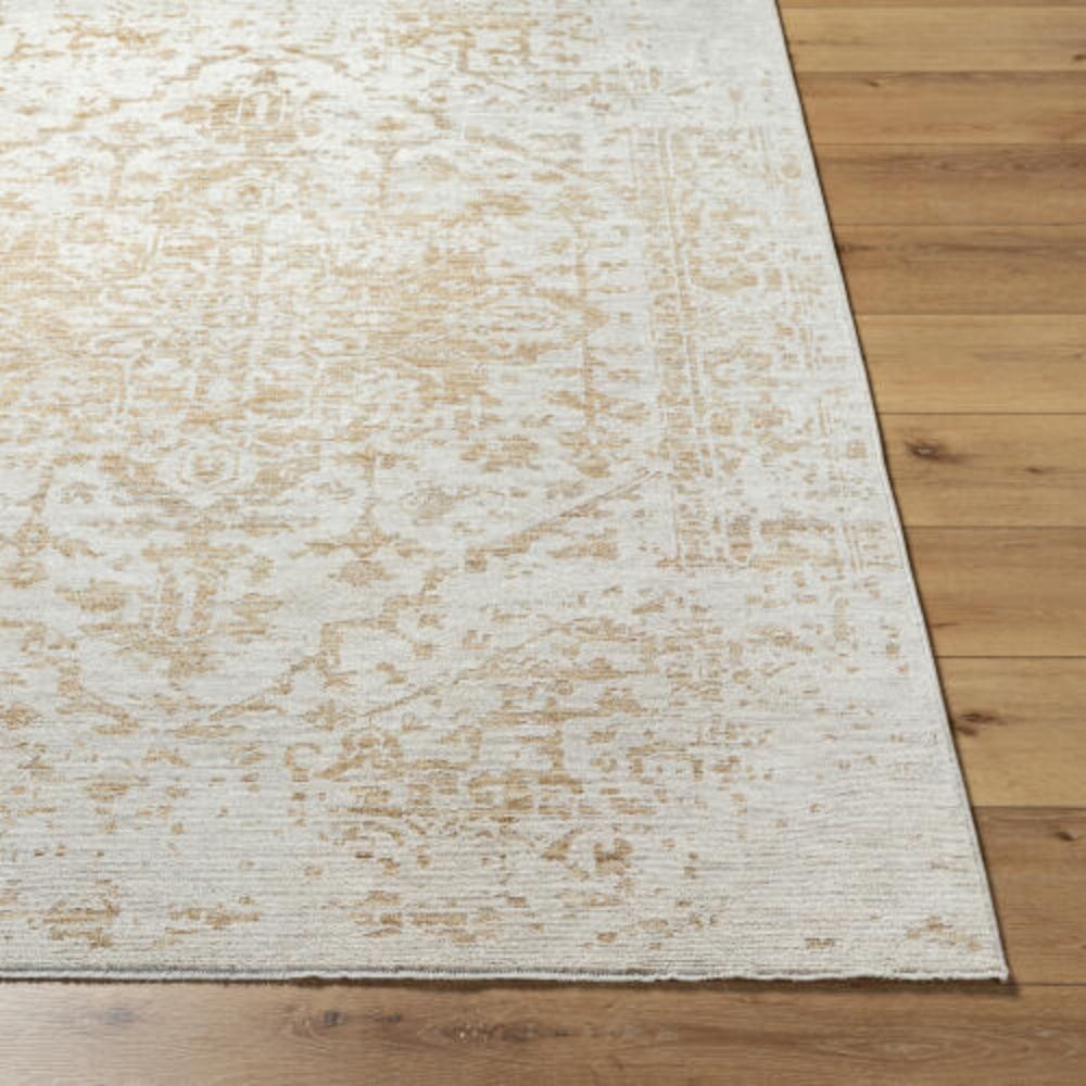 Beige and ivory machine woven rug with a soft medallion and distressed traditional pattern.
