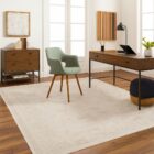 Neutral traditional rug in soft beige and cream with an all-over floral pattern and subtle distressed detailing.