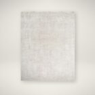 Neutral machine woven rug with subtle tonal texture in soft beige and ivory.