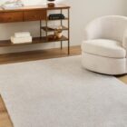 Neutral machine woven rug with subtle tonal texture in soft beige and ivory.