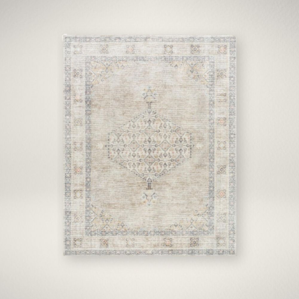 SU LILA RUG Faded traditional rug in beige, cream, and grey with a central medallion and distressed border.