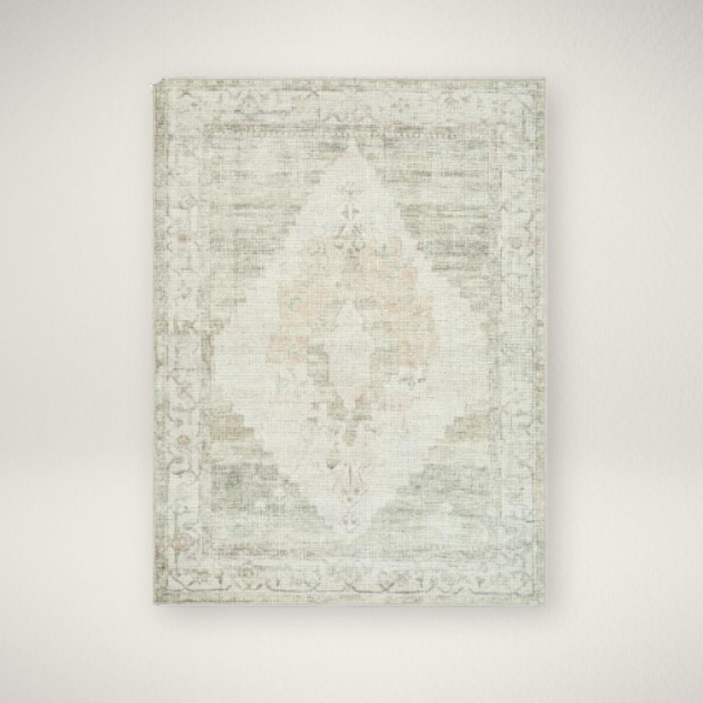 SU LUCA RUG Vintage-inspired woven rug with a faded diamond medallion in muted green, ivory, and blush tones.