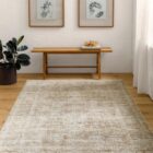 Neutral machine-woven rug in warm beige and taupe tones with a softly distressed, layered pattern.
