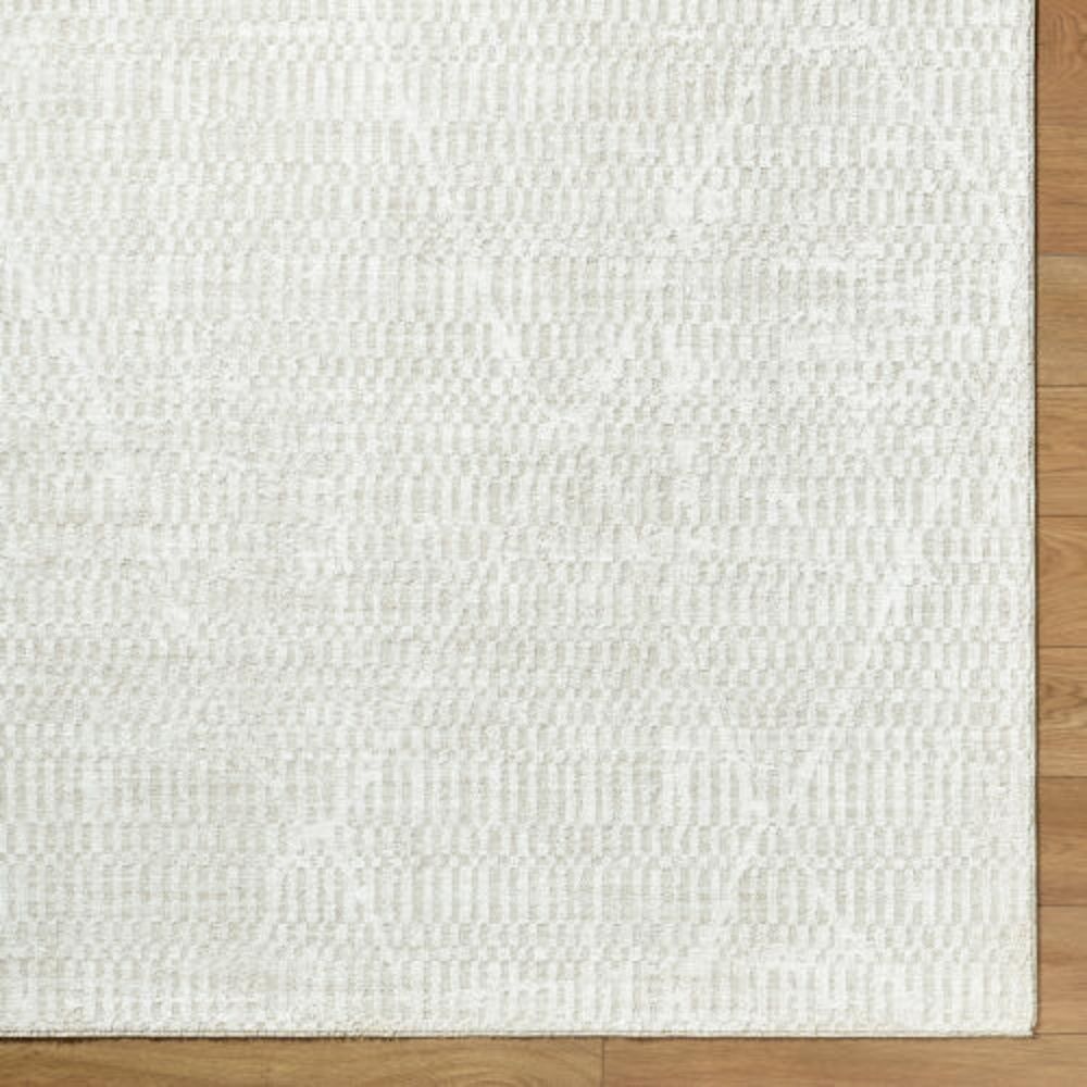 Beige and ivory machine woven rug with a soft medallion and distressed traditional pattern.