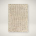 Neutral woven area rug in warm beige and ivory tones with subtle texture.