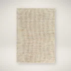 Neutral woven area rug in warm beige and ivory tones with subtle texture.