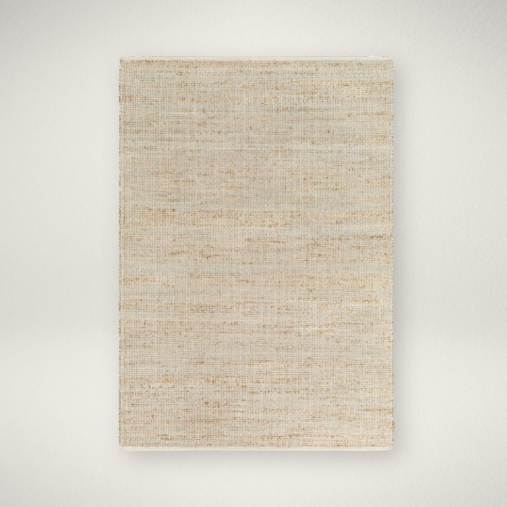 SY DEMI HANDMADE RUG Neutral woven area rug in warm beige and ivory tones with subtle texture.