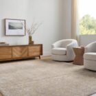 Traditional machine woven rug with ornate medallion and border design in warm beige and ivory tones.