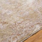 Traditional machine woven rug with ornate medallion and border design in warm beige and ivory tones.
