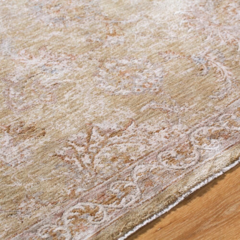 Traditional machine woven rug with ornate medallion and border design in warm beige and ivory tones.