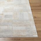 Neutral patchwork-style machine woven rug with geometric linear patterns in beige, taupe, and ivory.