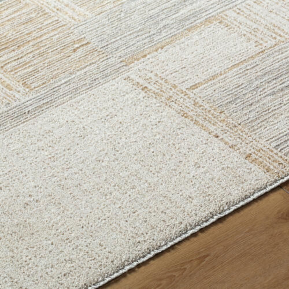 Neutral patchwork-style machine woven rug with geometric linear patterns in beige, taupe, and ivory.