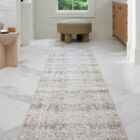 Traditional patterned area rug in soft neutral tones of beige, ivory, and grey.