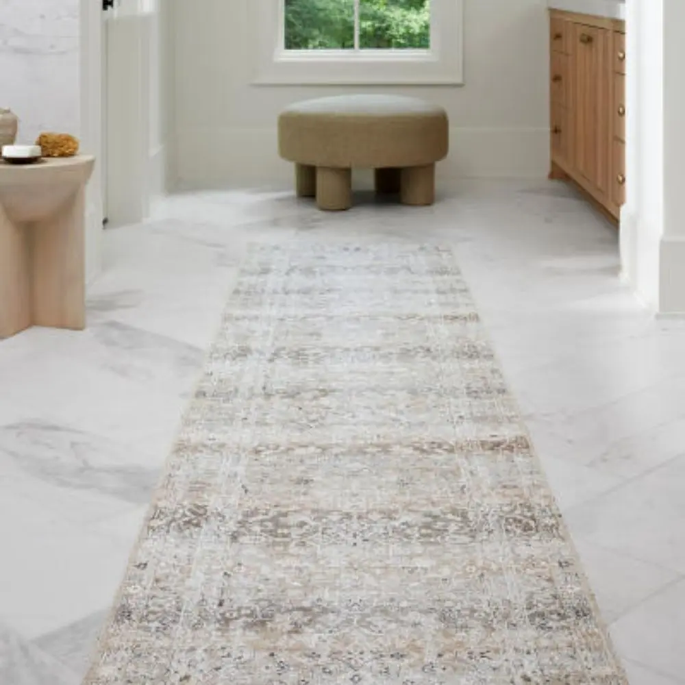 Traditional patterned area rug in soft neutral tones of beige, ivory, and grey.