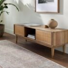 Neutral traditional area rug with soft distressed patterns in beige, ivory, and grey tones.