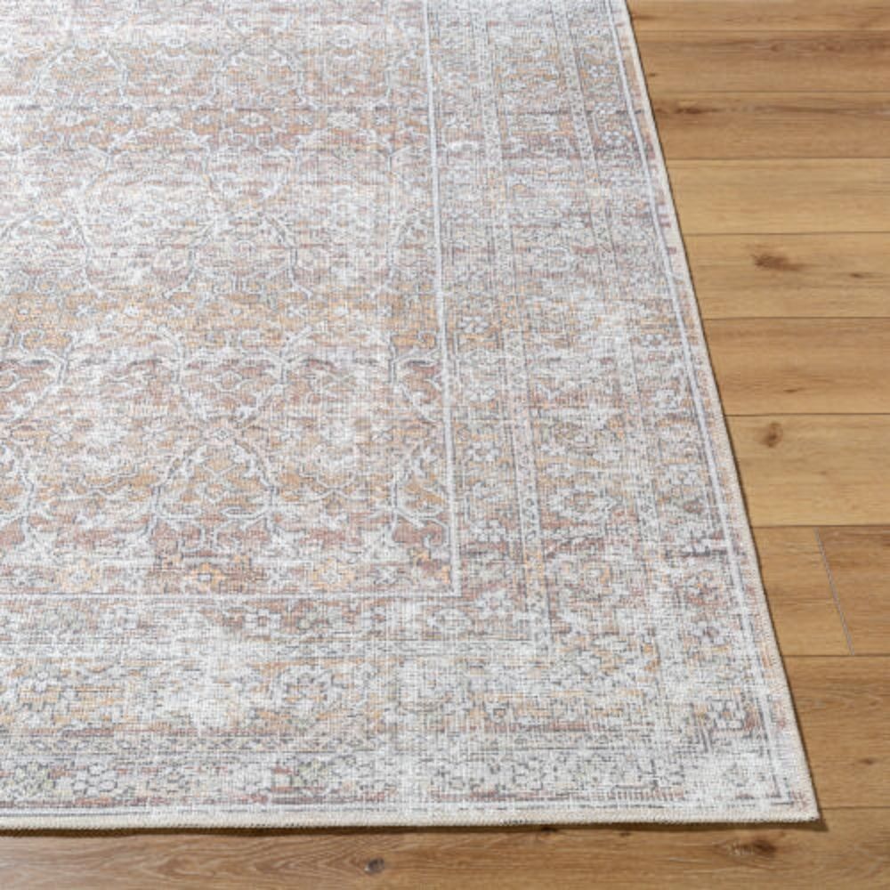Neutral traditional area rug with soft distressed patterns in beige, ivory, and grey tones.