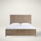 A rustic modern panel bed with a woven wood lattice headboard and a solid wood footboard in a natural weathered finish.