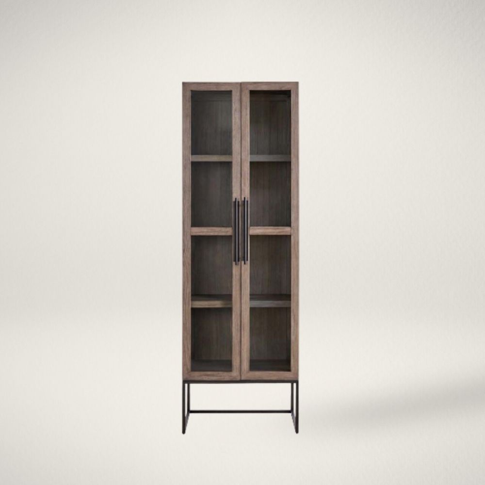 UN BOULDER CABINET Tall wood and glass cabinet with black metal base and long vertical handles.