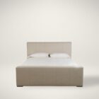 A modern upholstered bed in a soft beige fabric with clean lines, a low-profile footboard, and a tall rectangular headboard.