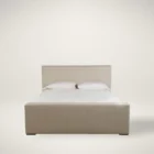 A modern upholstered bed in a soft beige fabric with clean lines, a low-profile footboard, and a tall rectangular headboard.