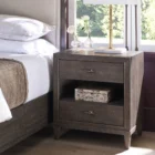 A 28-inch wide cocoa-finished nightstand with two drawers, an open center shelf, bronze hardware, and tapered legs.