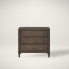 A 32-inch wide dark cocoa-finished nightstand with three drawers, bronze hardware, and tapered legs.