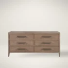 A six-drawer dresser in a light natural wood finish with long horizontal metal handles and tapered legs.