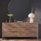 A six-drawer dresser in a light natural wood finish with long horizontal metal handles and tapered legs.