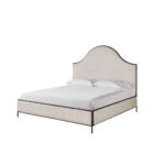 An upholstered bed in soft cream fabric with an arched headboard outlined by a slim dark metal frame, paired with a matching upholstered footboard.
