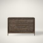 A four-drawer chest in a dark textured wood finish with elongated brass handles and slim tapered legs.
