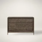 A four-drawer chest in a dark textured wood finish with elongated brass handles and slim tapered legs.