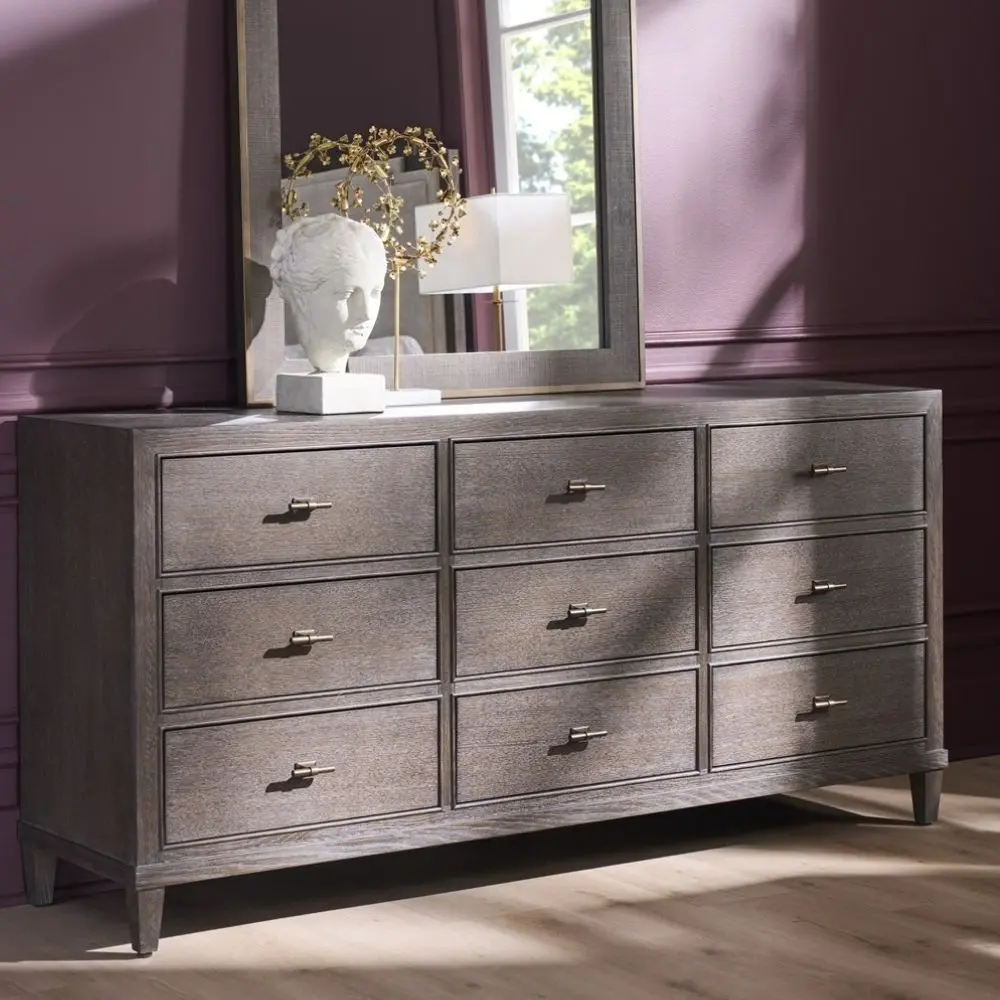 A nine-drawer dresser in a rich cocoa brown wood finish with textured grain, slim brass hardware, and tapered legs.