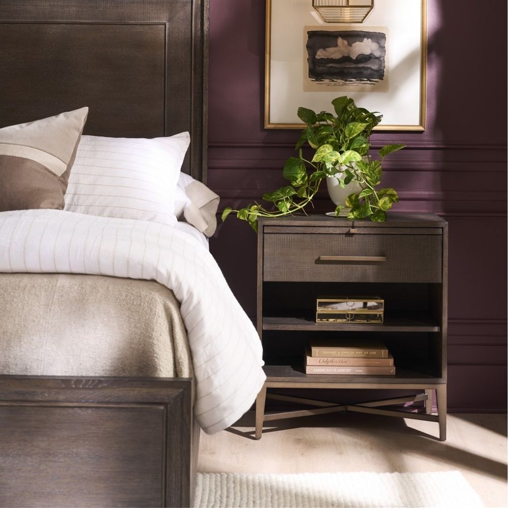 A 26-inch dark wood nightstand with one drawer, two open shelves, and a bronze-finished metal base with X-cross detailing.