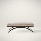 Modern bench with plush taupe cushion and sculptural black arched base.