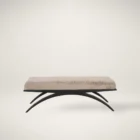 Modern bench with plush taupe cushion and sculptural black arched base.