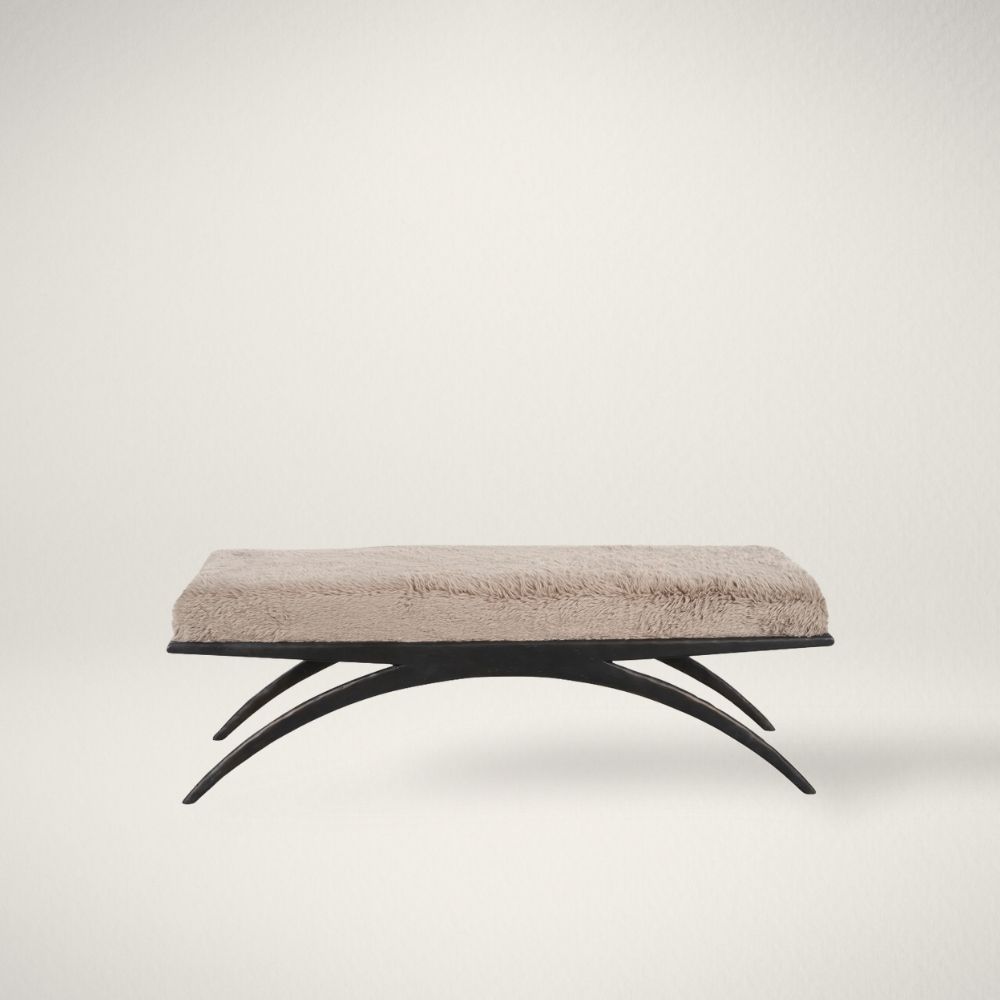 UN NOLA Modern bench with plush taupe cushion and sculptural black arched base.