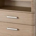 A modern nightstand in a light natural wood finish with two drawers, a sleek silver handle design, and an open storage shelf.