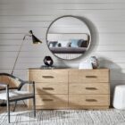 A modern six-drawer dresser in a light natural wood finish with clean lines and sleek silver hardware.