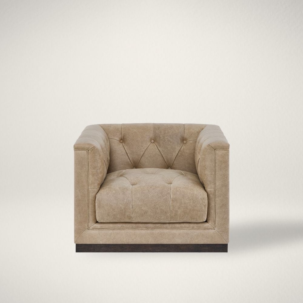 UN QUINN SWIVEL CHAIR c Square tufted leather swivel chair with deep seat and modern silhouette.