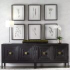 Set of six framed botanical prints featuring delicate illustrations of grasses and plants in green tones on white backgrounds with dark frames.