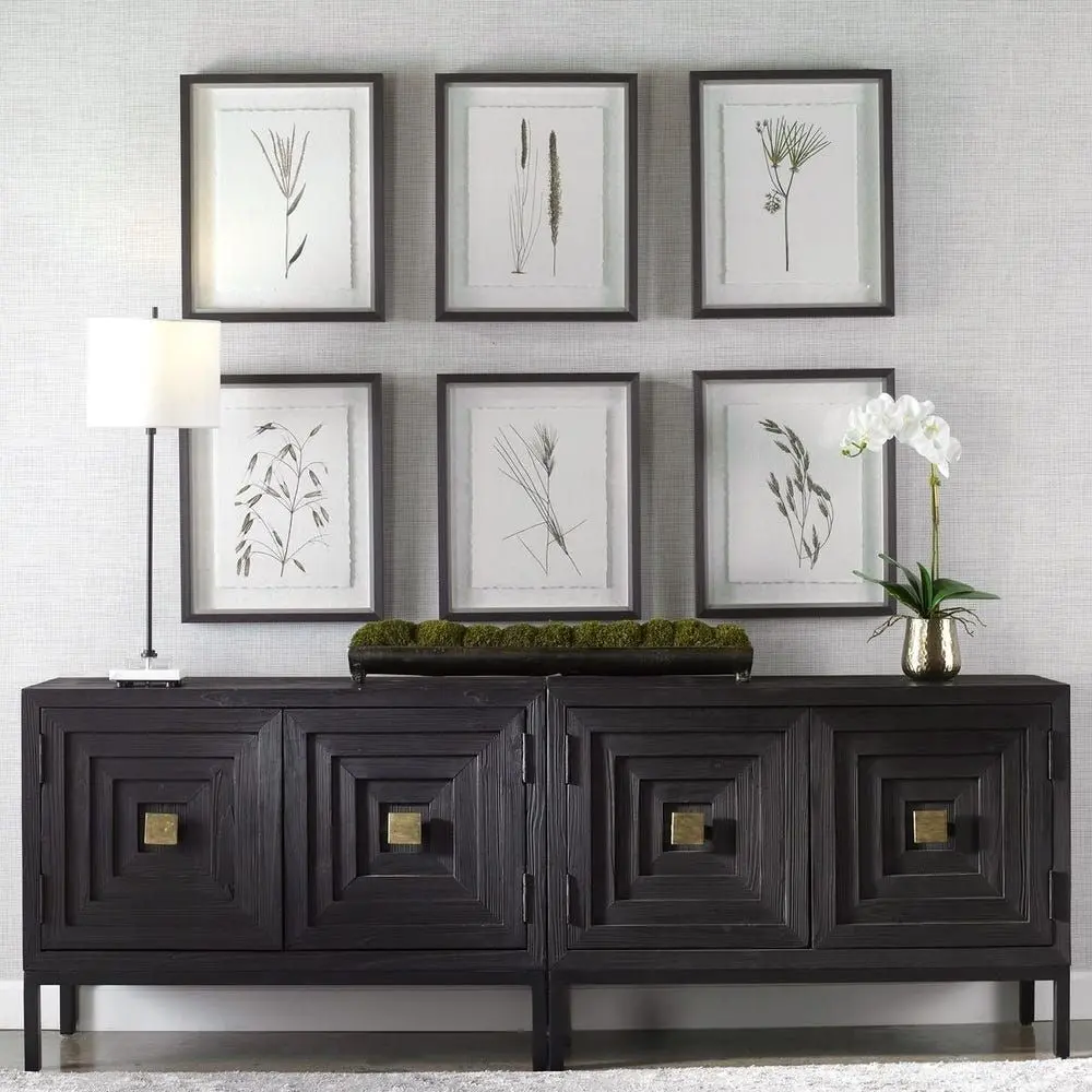 Set of six framed botanical prints featuring delicate illustrations of grasses and plants in green tones on white backgrounds with dark frames.