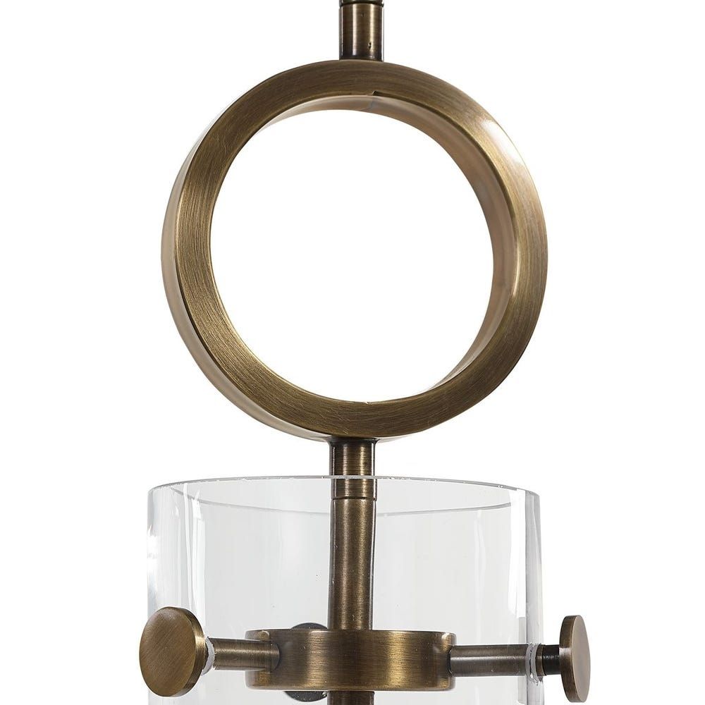 Modern sconce with a clear glass cone shade, antique brass accents, and an exposed bulb design.
